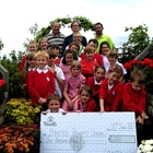 The pupils of Binsted Primary School receiving the £1,000 cheque